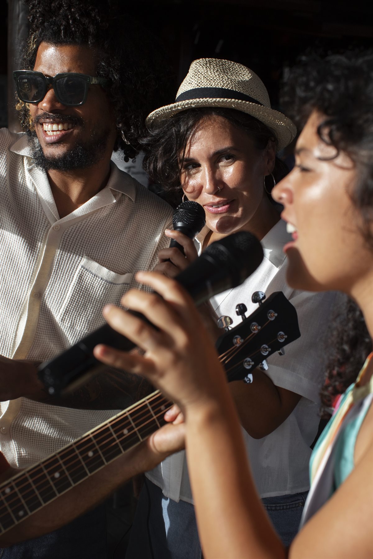 Friends singing with guitars during a sunny RockaRita jam session